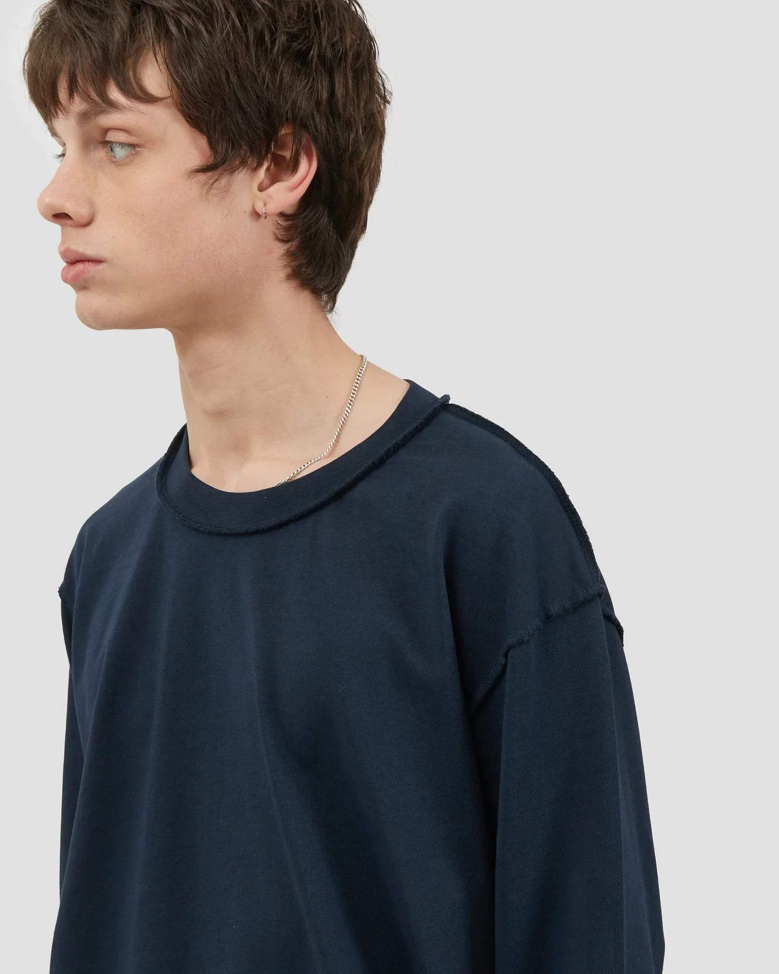Model wearing the Fairly Normal Reversed Longsleeve in navy, showing the inside-out seams and generous neckline